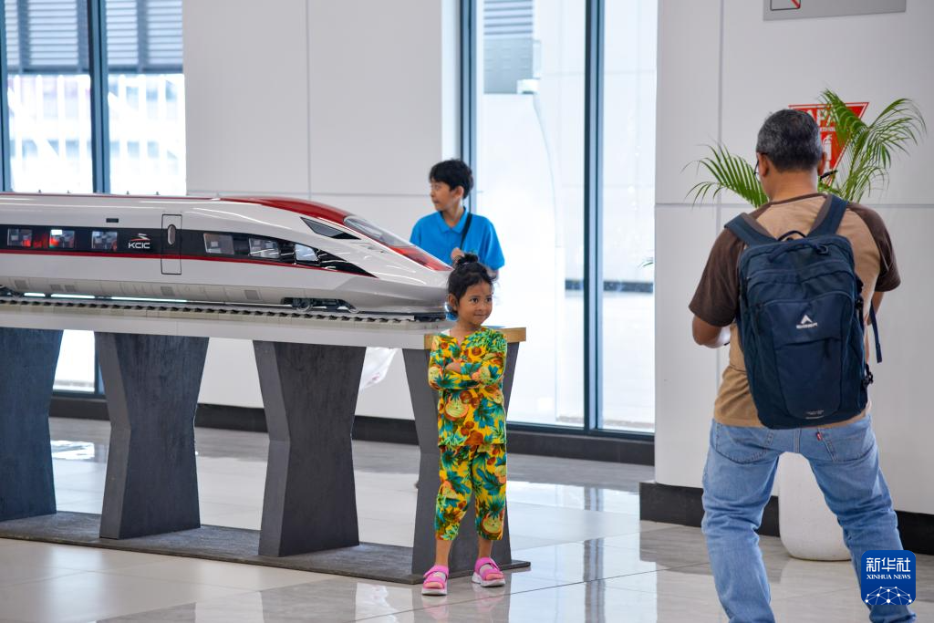 1月24日，在印度尼西亞雅加達(dá)哈利姆站候車大廳，一名小朋友和雅萬高鐵高速動(dòng)車組模型合影。新華社記者 徐欽 攝