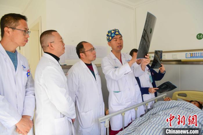 圖為醫(yī)療援藏專家何蔚(站右二)與馮敬云(左二)、廖濤(左三)等人討論患者病情。(資料圖) 貢嘎來(lái)松 攝