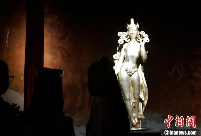 圖為觀眾正在欣賞展覽中的雕塑作品《八萬四千年》?！±盍?攝